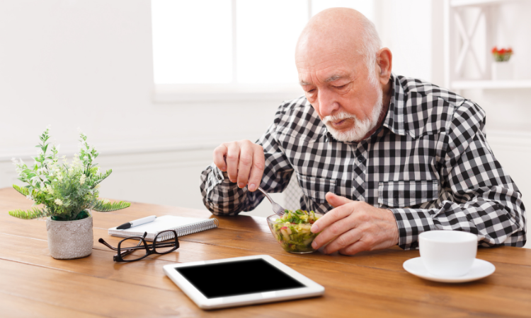 Older Gentleman eating salad