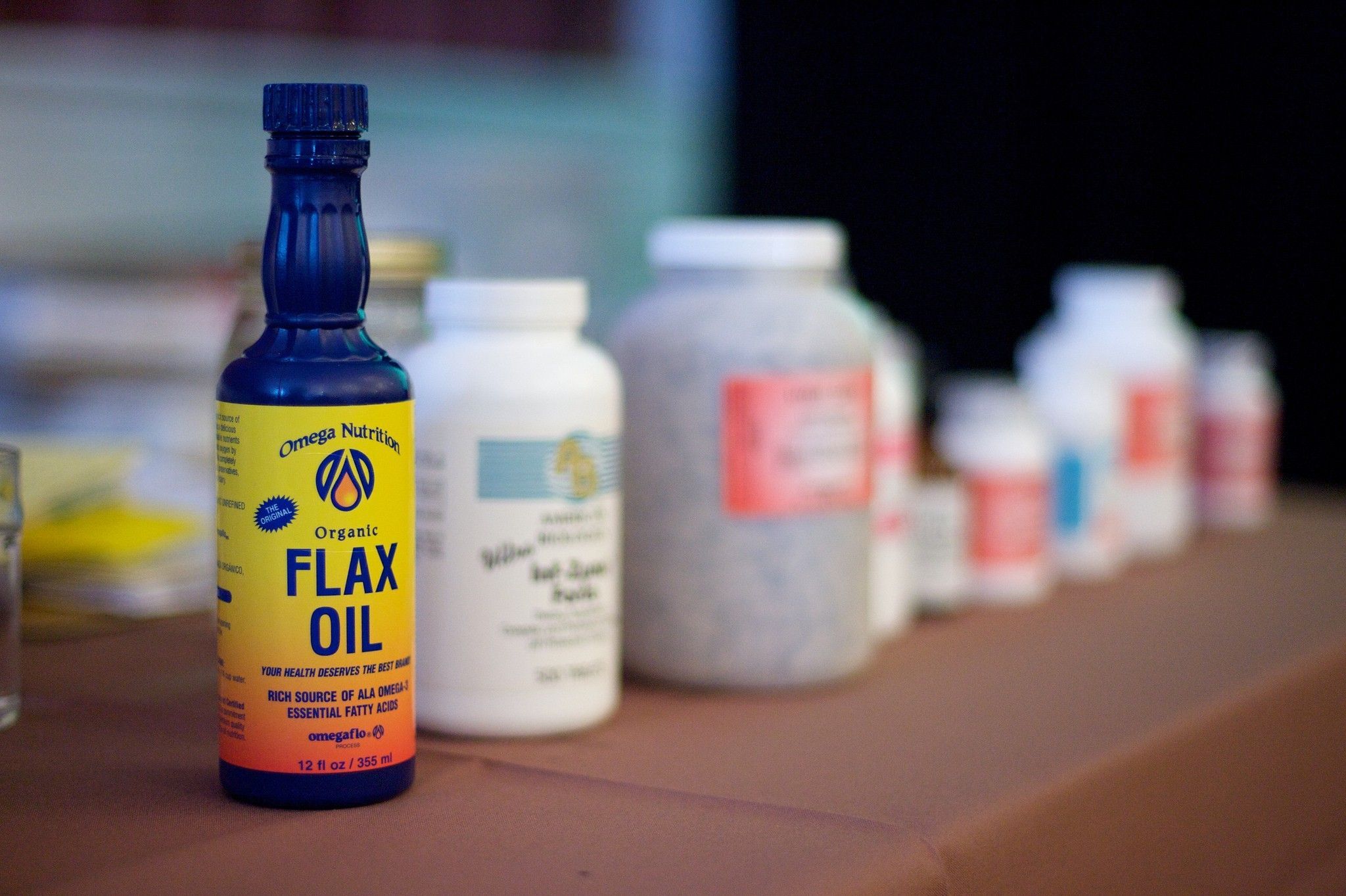 Bottle of flax oil alongside other supplements